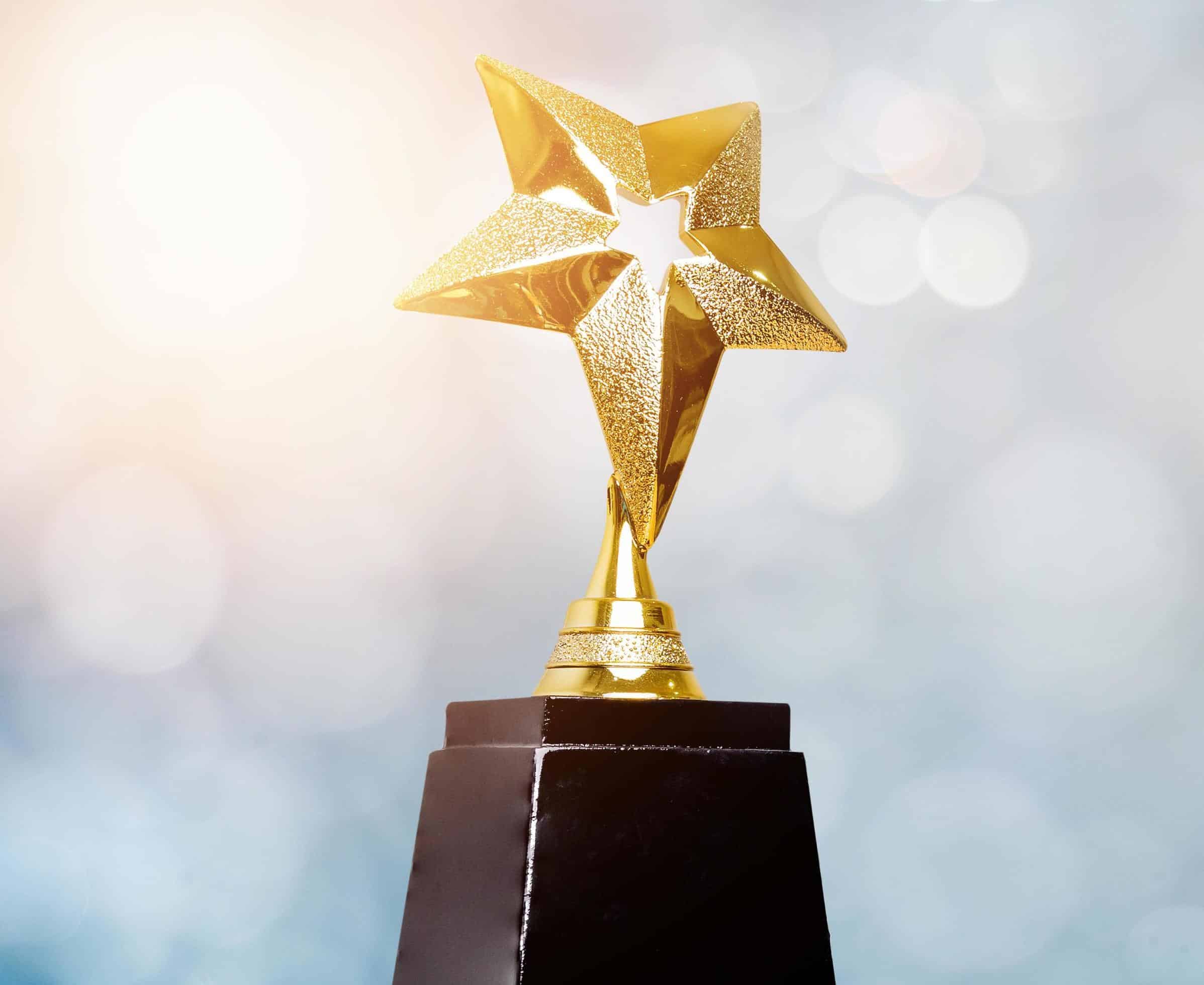 golden-trophy-award-bokeh-soft-blue-background-copy-space-for-text-winner-or-1st-place-gold-trophy-award-concept-free-photo