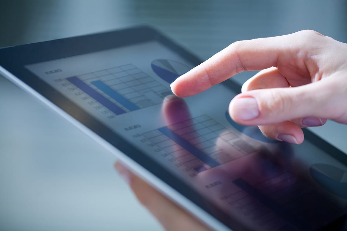 17216784 - close-up of female hands touching digital tablet with business diagram