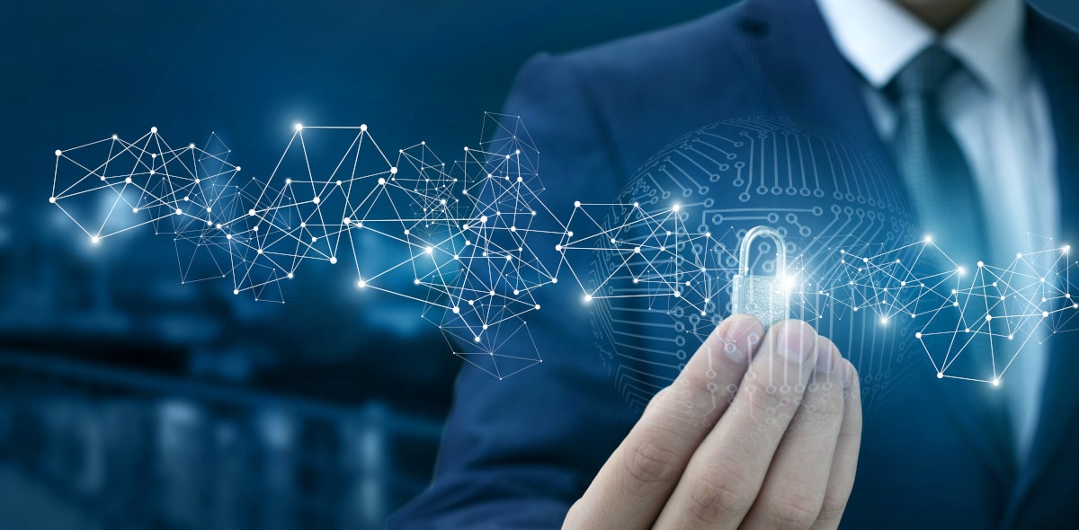 Lock for protection of the network in the hands of a businessman on a blurred background.