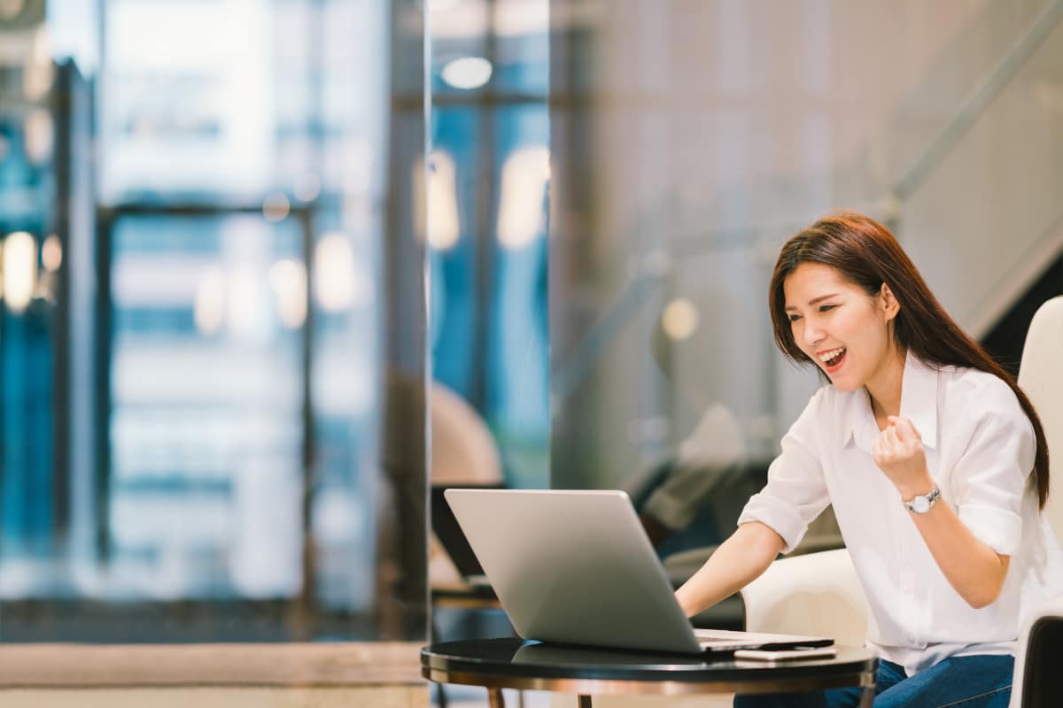 Beautiful Asian girl celebrate with laptop, success pose, education or technology or startup business concept, with copy space