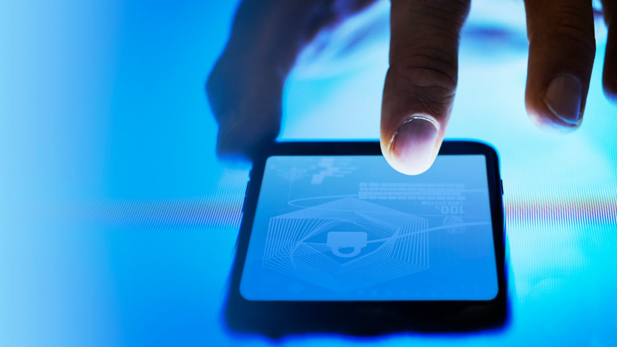 Man scanning his finger on his phone screen