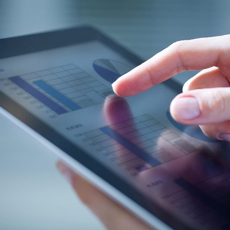 17216784 - close-up of female hands touching digital tablet with business diagram